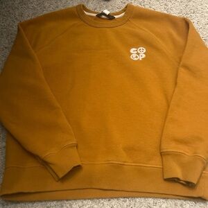 Women’s mustard colored REI sweatshirt